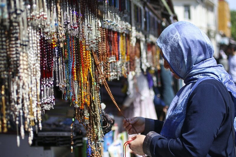 Turkish woman buying prayer beads